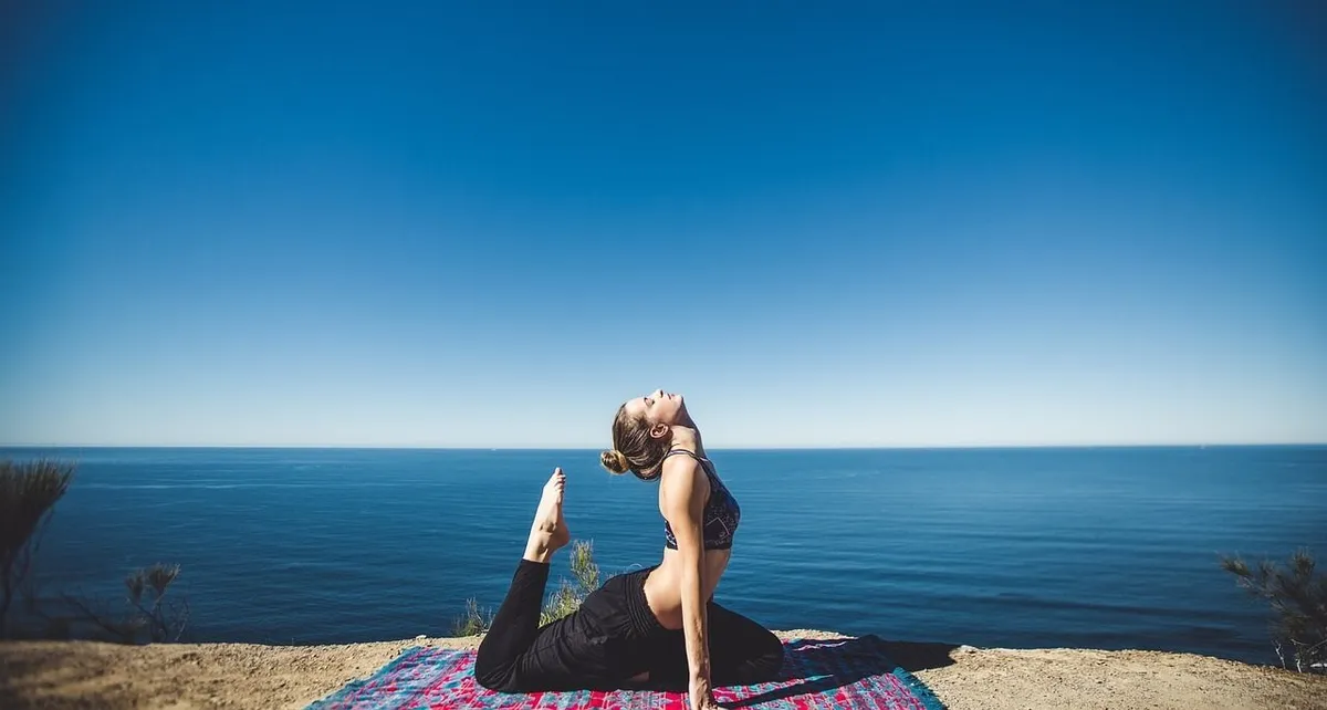 Person seated tall gently tilting the head toward one shoulder in a neck release stretch