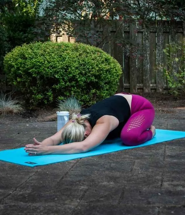 Person resting in child's pose
