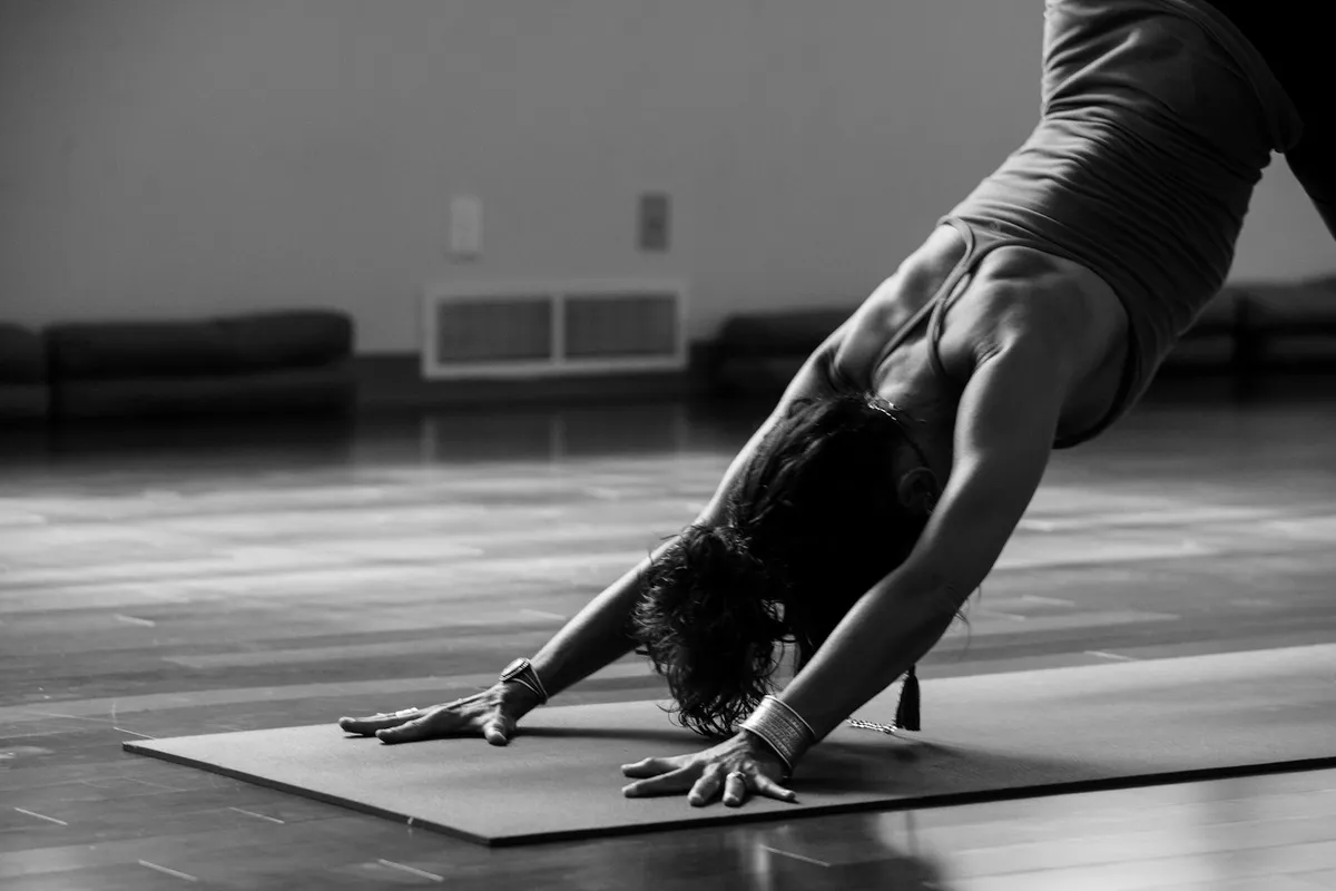 Person in downward-facing dog pose lengthening the backs of the legs