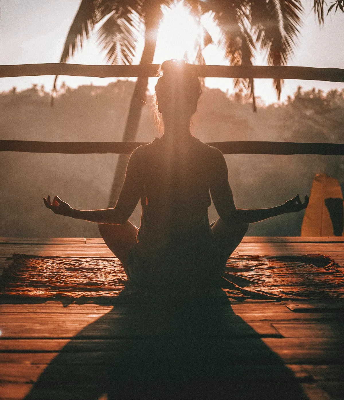 Silhouette of a person sitting quietly against a soft, calm background