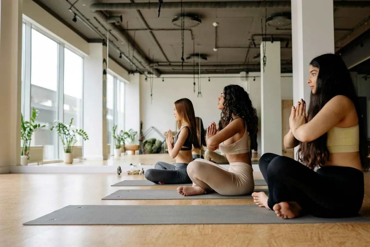 Person seated cross-legged with eyes closed in a calm breathing practice