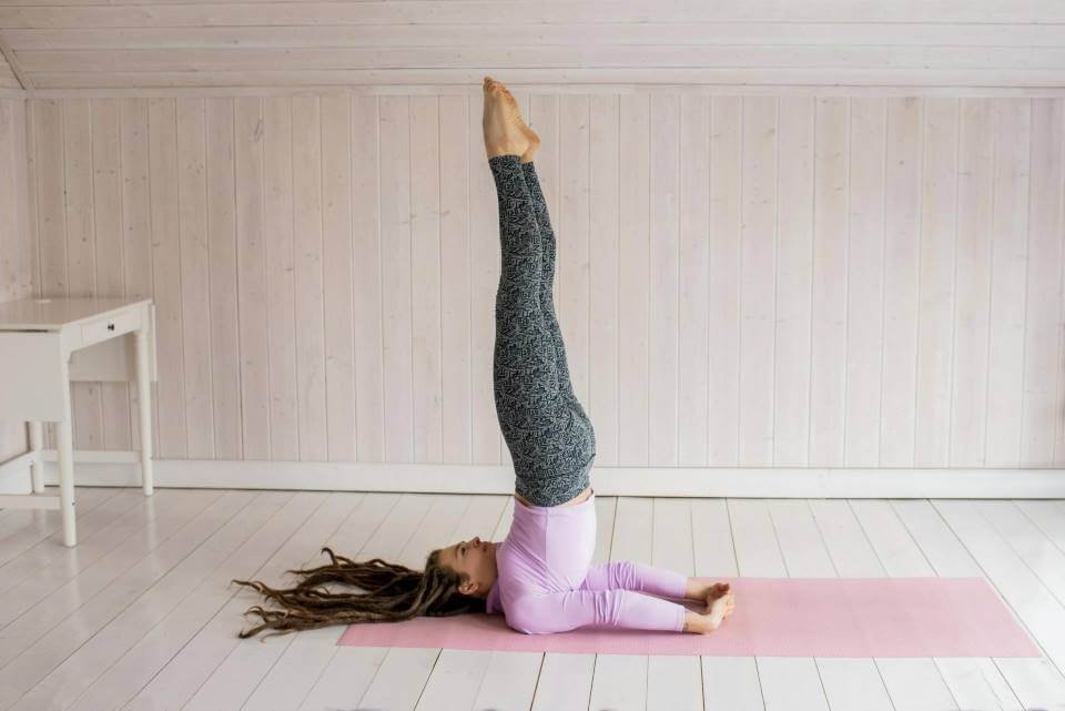 girl doing shoulder stand yoga to fix thyroid issue