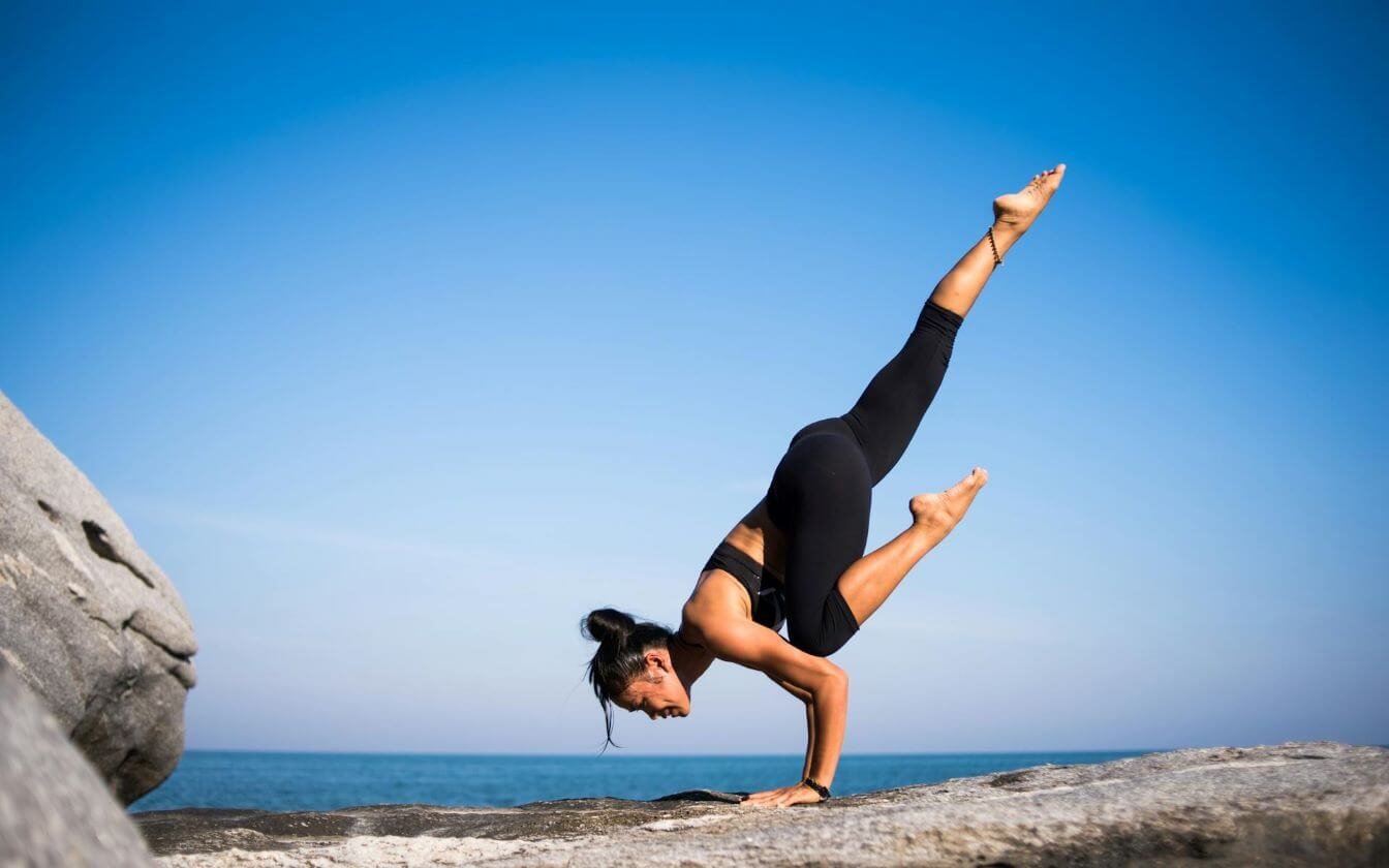 girl doing yoga to strengthen arms